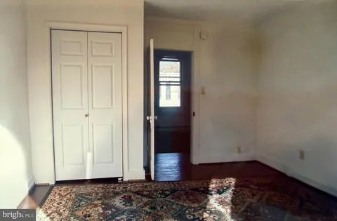 a view of kitchen with wooden floor and cabinets