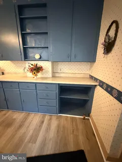 a kitchen with kitchen island a stove a sink and cabinets