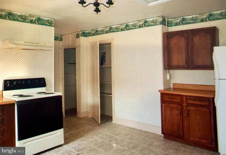 a kitchen with a stove and white cabinets