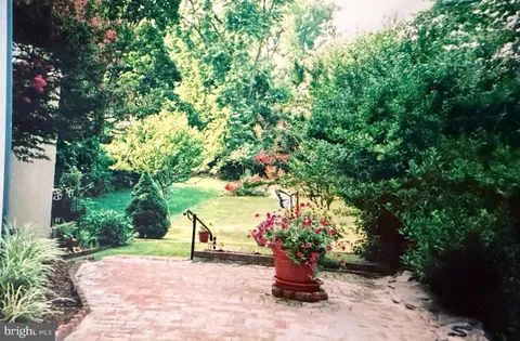 a view of a garden with flowers and trees
