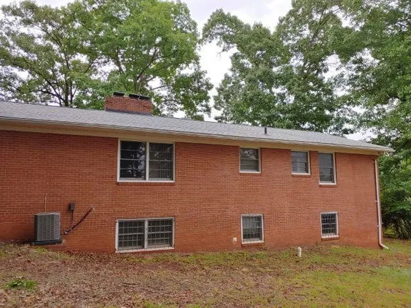 a front view of a house with a tree