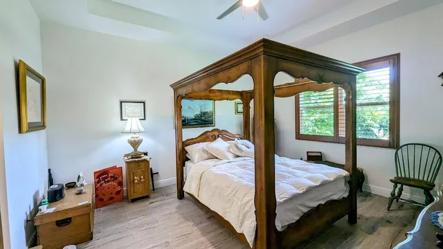 a bedroom with bed and a large window