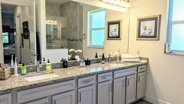 a bathroom with double sink and a mirror