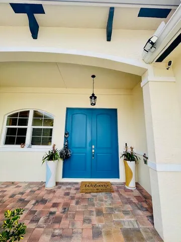 a view of a hallway with wooden floor and a window