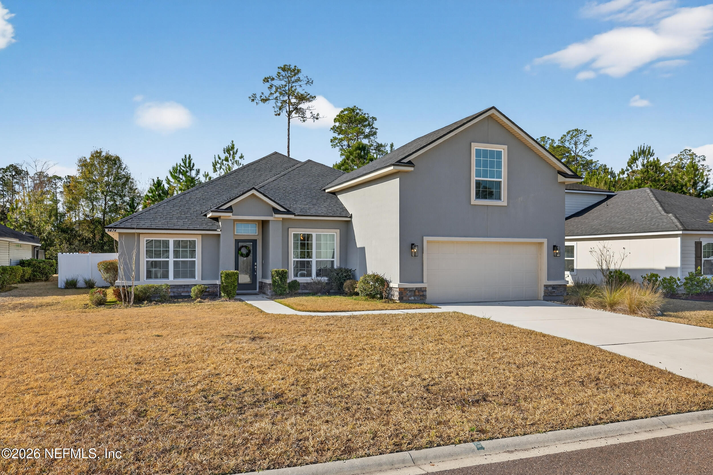 9874 Patriot Ridge Drive Jacksonville, FL 32221 - Photo 1 of 26 a front view of a house with a yard
