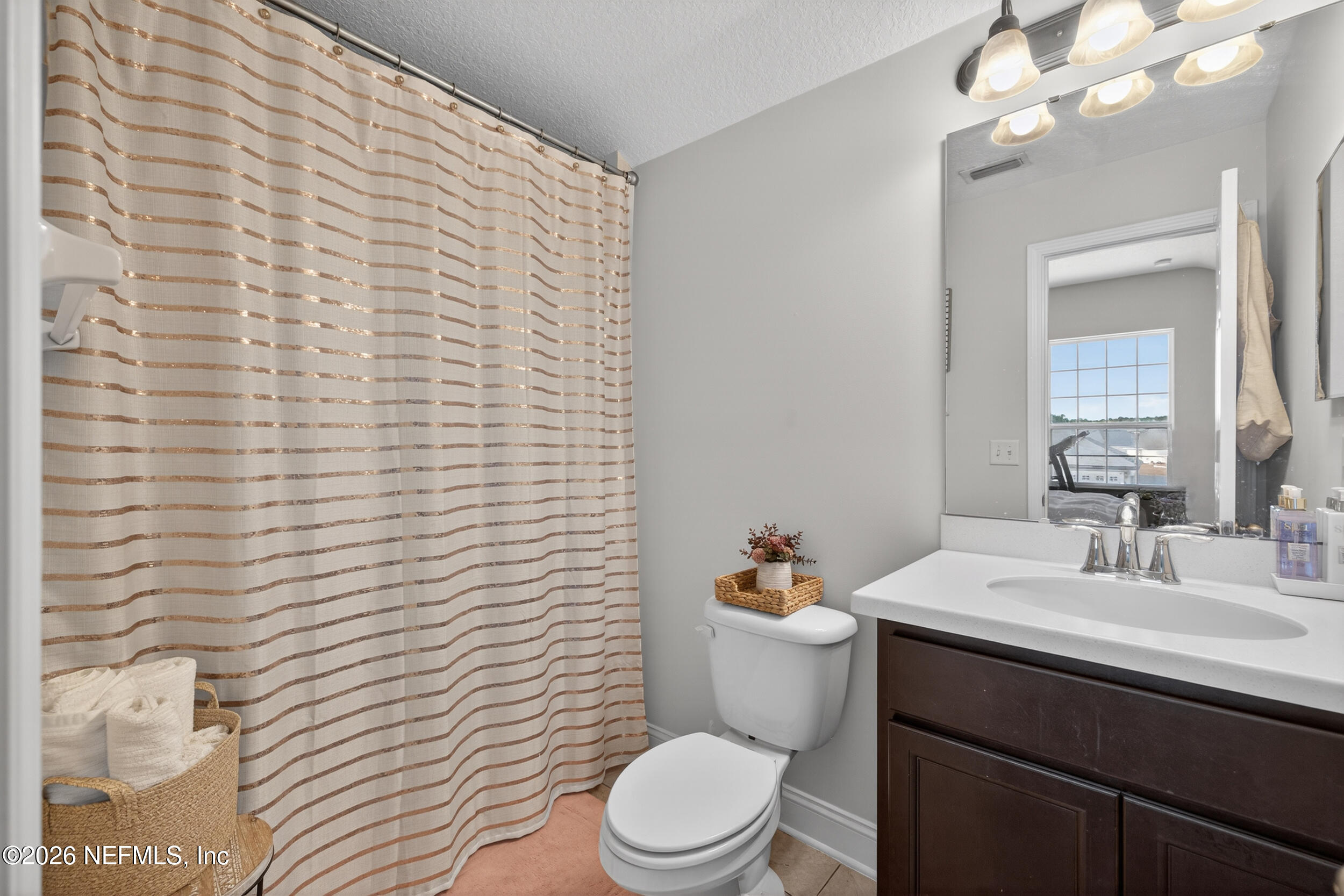 9874 Patriot Ridge Drive Jacksonville, FL 32221 - Photo 18 of 26 a bathroom with a sink a toilet and mirror