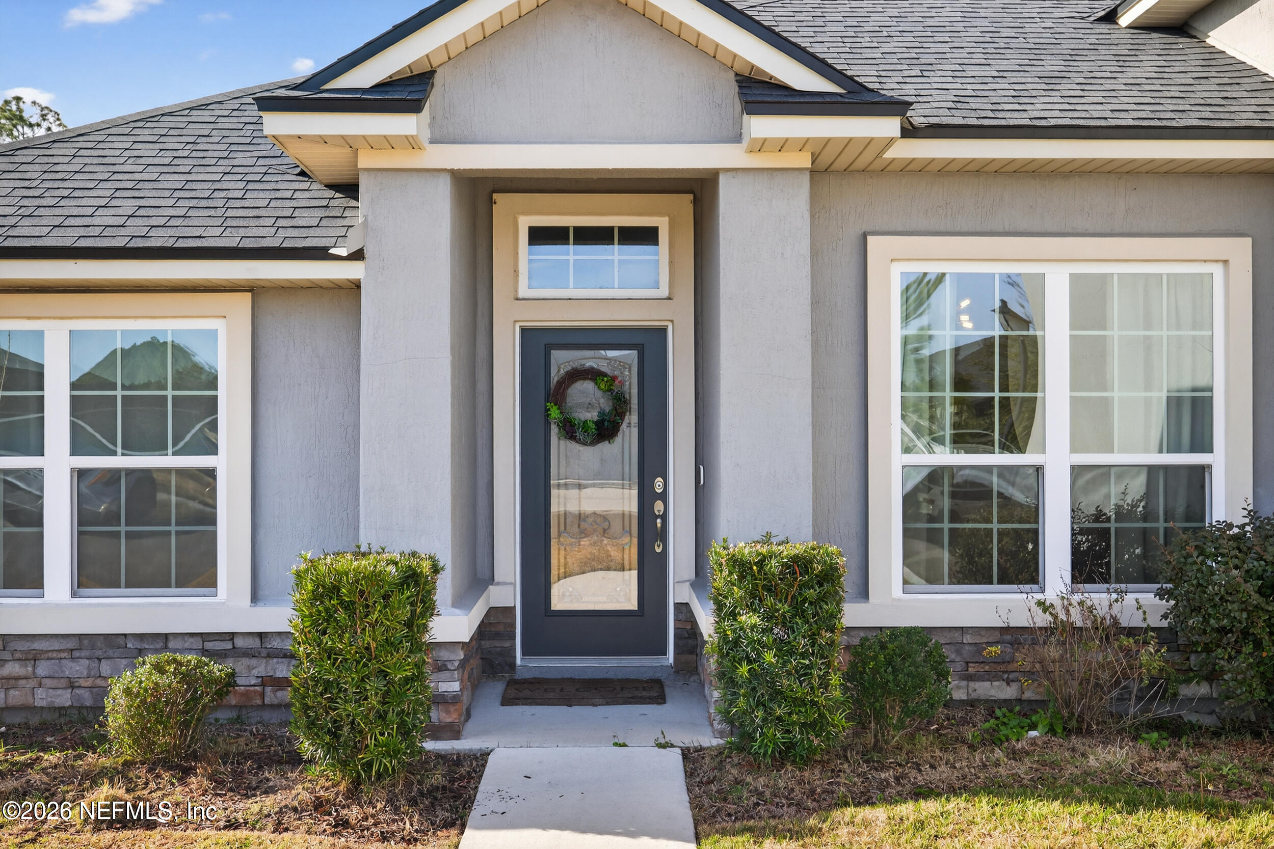9874 Patriot Ridge Drive Jacksonville, FL 32221 - Photo 2 of 26 a front view of a house with garden