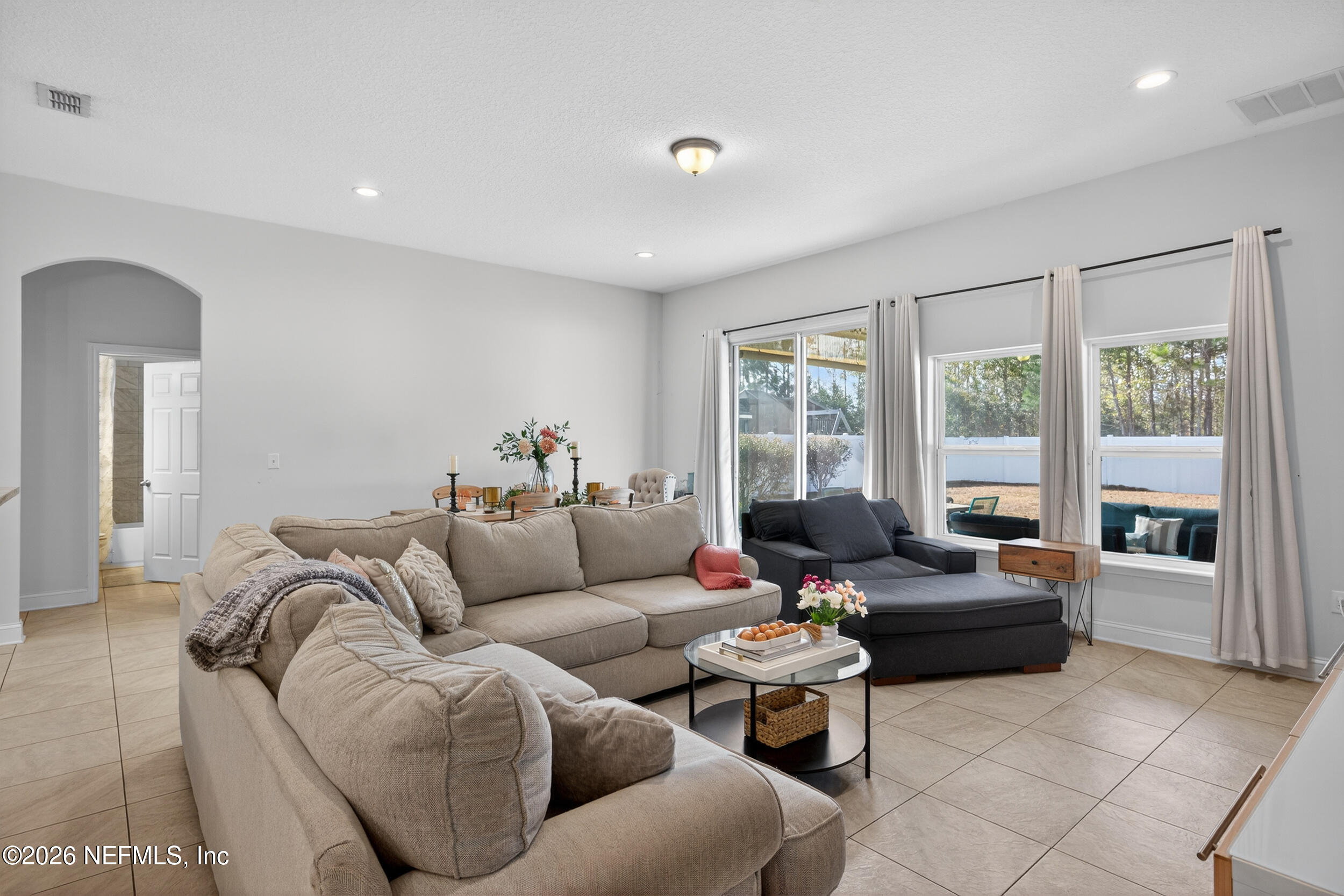 9874 Patriot Ridge Drive Jacksonville, FL 32221 - Photo 6 of 26 a living room with furniture and large windows