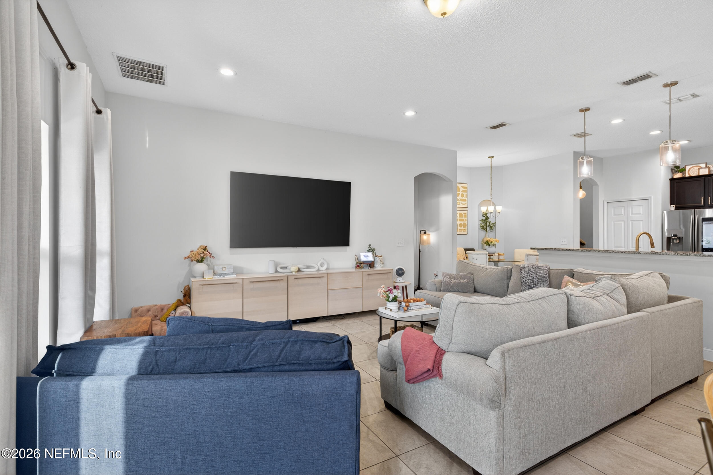 9874 Patriot Ridge Drive Jacksonville, FL 32221 - Photo 7 of 26 a living room with furniture and a flat screen tv