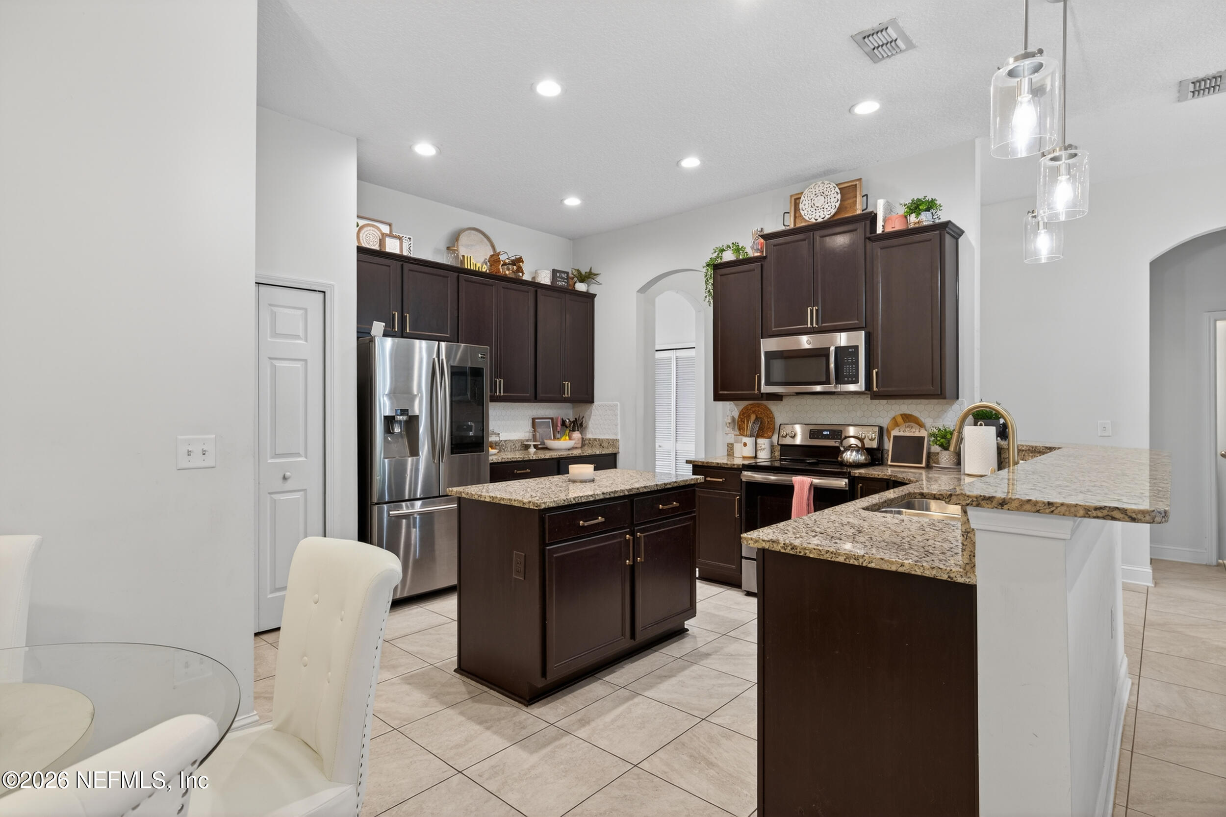 9874 Patriot Ridge Drive Jacksonville, FL 32221 - Photo 8 of 26 a kitchen with stainless steel appliances granite countertop a sink stove and refrigerator