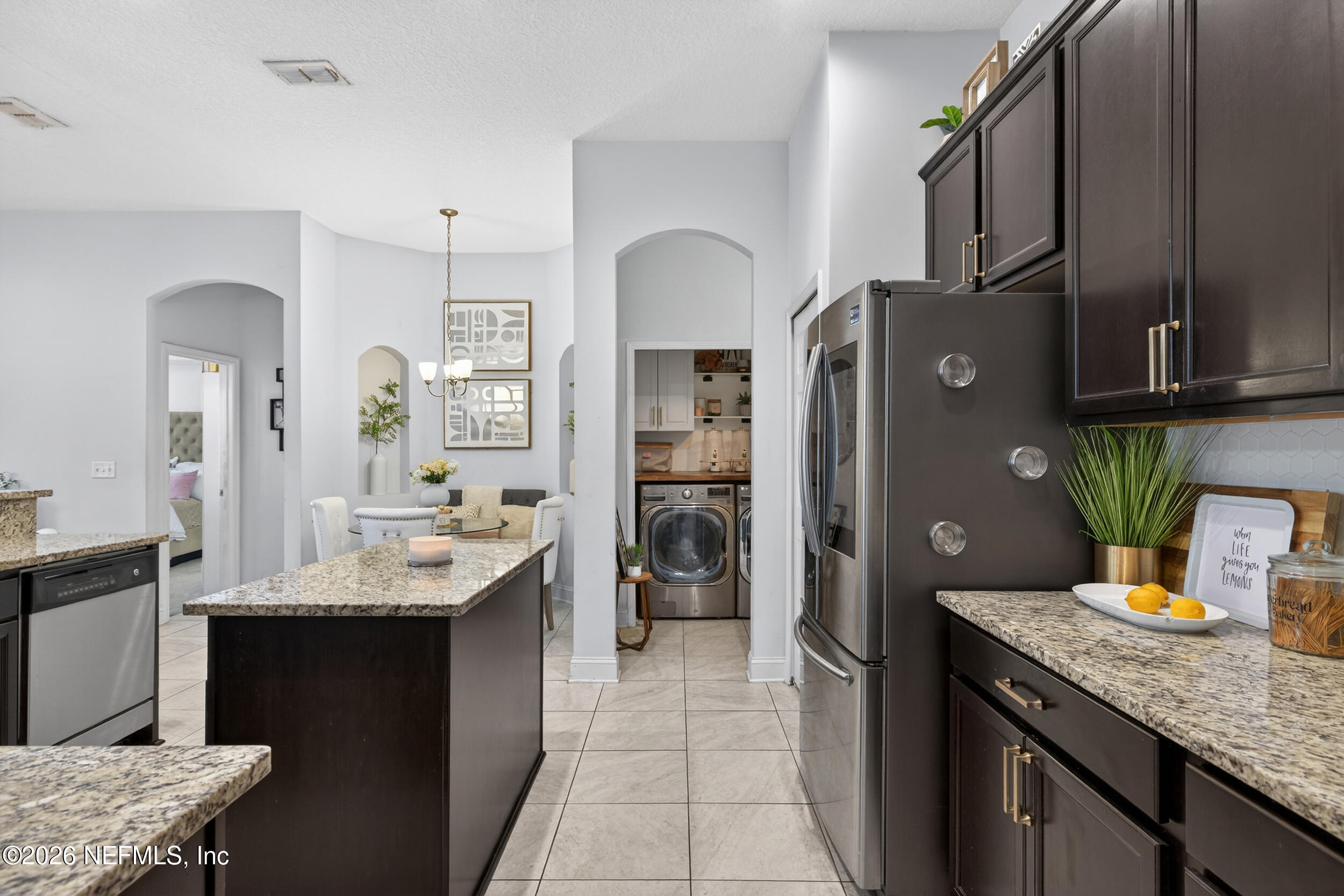 9874 Patriot Ridge Drive Jacksonville, FL 32221 - Photo 9 of 26 a kitchen with stainless steel appliances granite countertop a sink refrigerator and cabinets