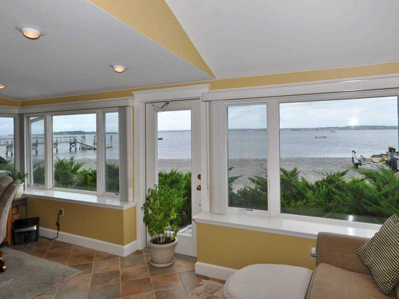 16 East Shore Road Jamestown, RI 02835 - Photo 9 of 20 Den/Family/Great Room. A former porch now incorporated into the house offers a wall of windows.