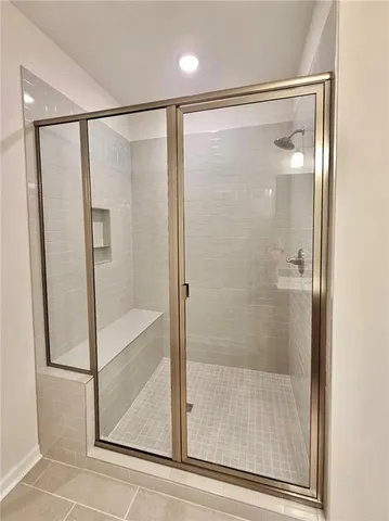 a bathroom with a glass shower door