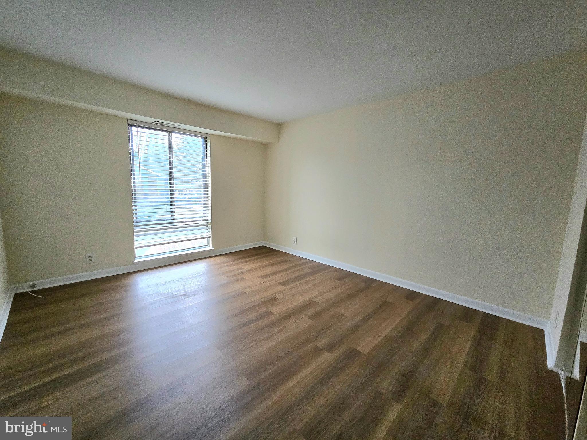 114 Van Buren Road, Unit 5 Voorhees, NJ 08043 - Photo 12 of 13 a view of an empty room with wooden floor and fan