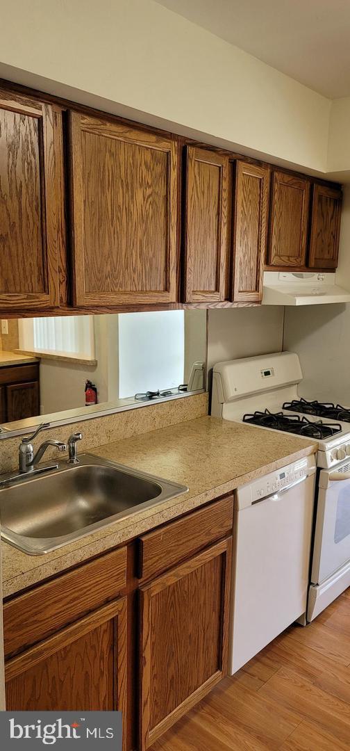 114 Van Buren Road, Unit 5 Voorhees, NJ 08043 - Photo 3 of 11 a kitchen with a sink cabinets and a wooden floor