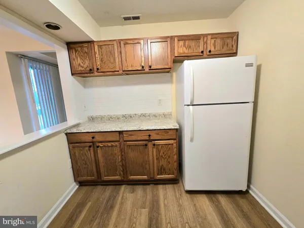 a white refrigerator freezer sitting inside of a kitchen