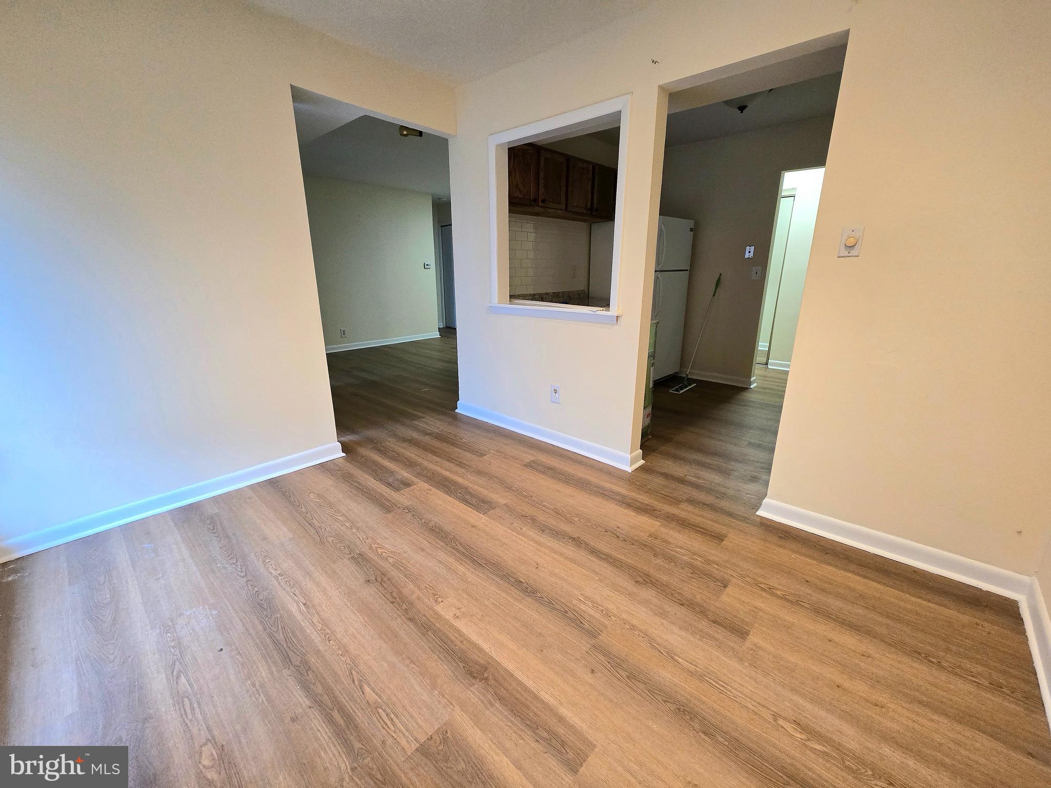 114 Van Buren Road, Unit 5 Voorhees, NJ 08043 - Photo 8 of 13 an empty room with wooden floor and entrance
