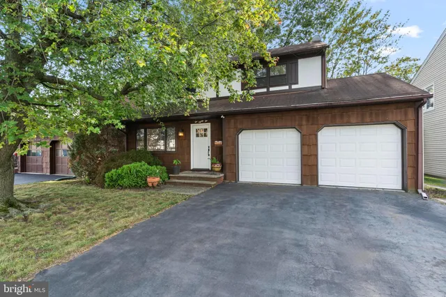 a front view of a house with outdoor seating