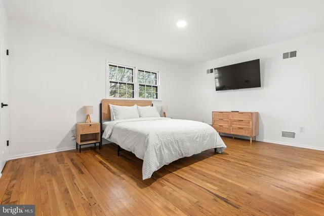 a bedroom with two beds and a window