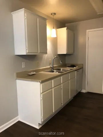 a kitchen with sink and cabinets