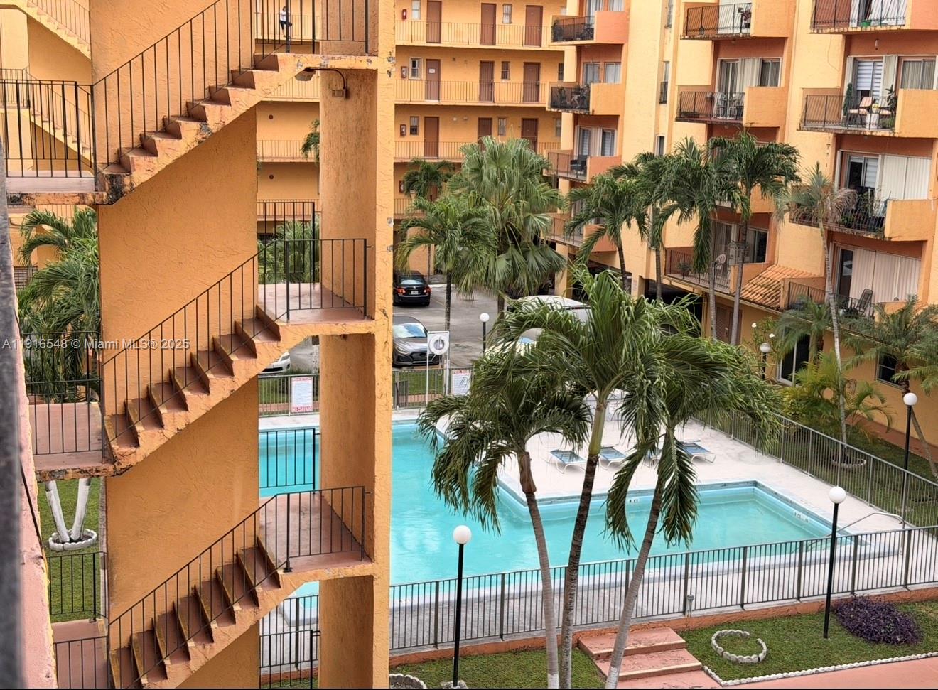 1900 West 54th Street, Unit 320 Hialeah, FL 33012 - Photo 1 of 19 a view of a tall building next to a road