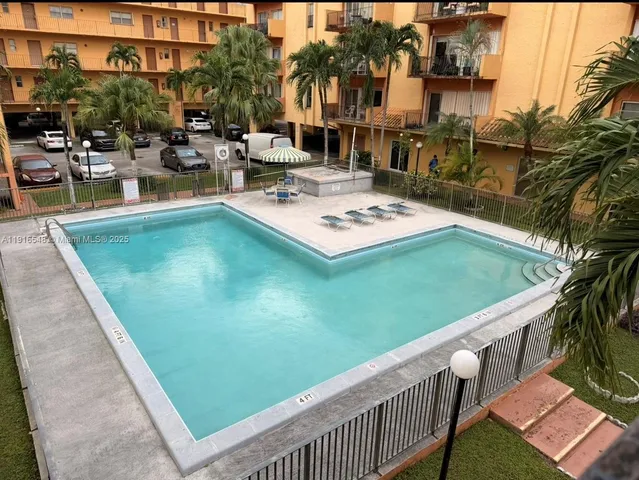 a view of a swimming pool with outdoor seating