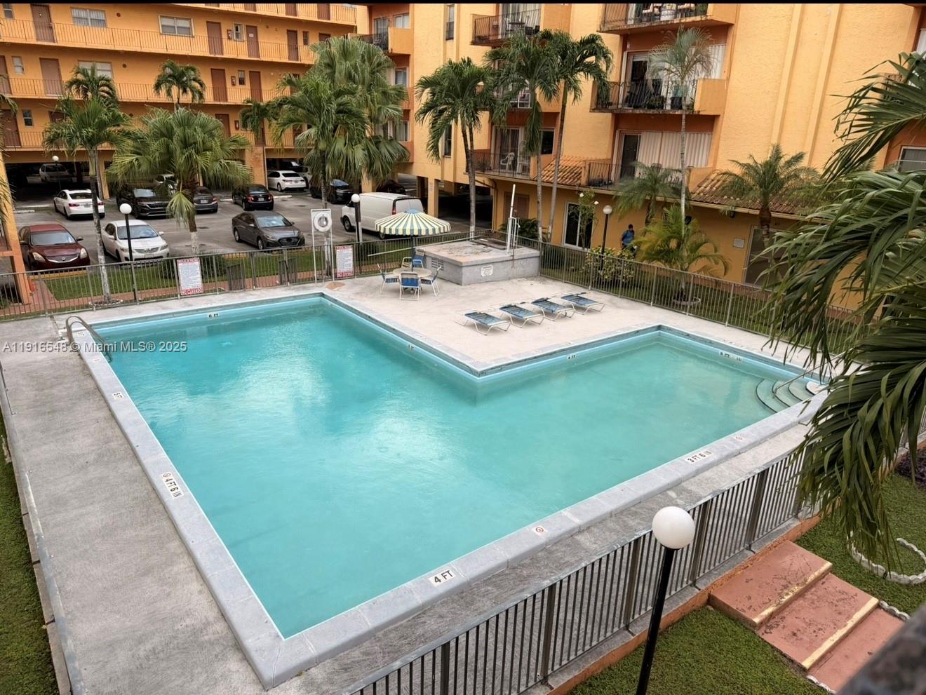 1900 West 54th Street, Unit 320 Hialeah, FL 33012 - Photo 2 of 19 a view of a swimming pool with outdoor seating