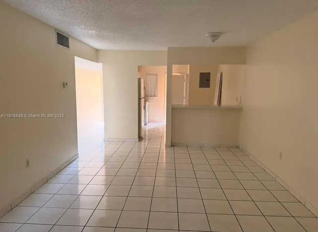 a view of a livingroom with an empty space and a window