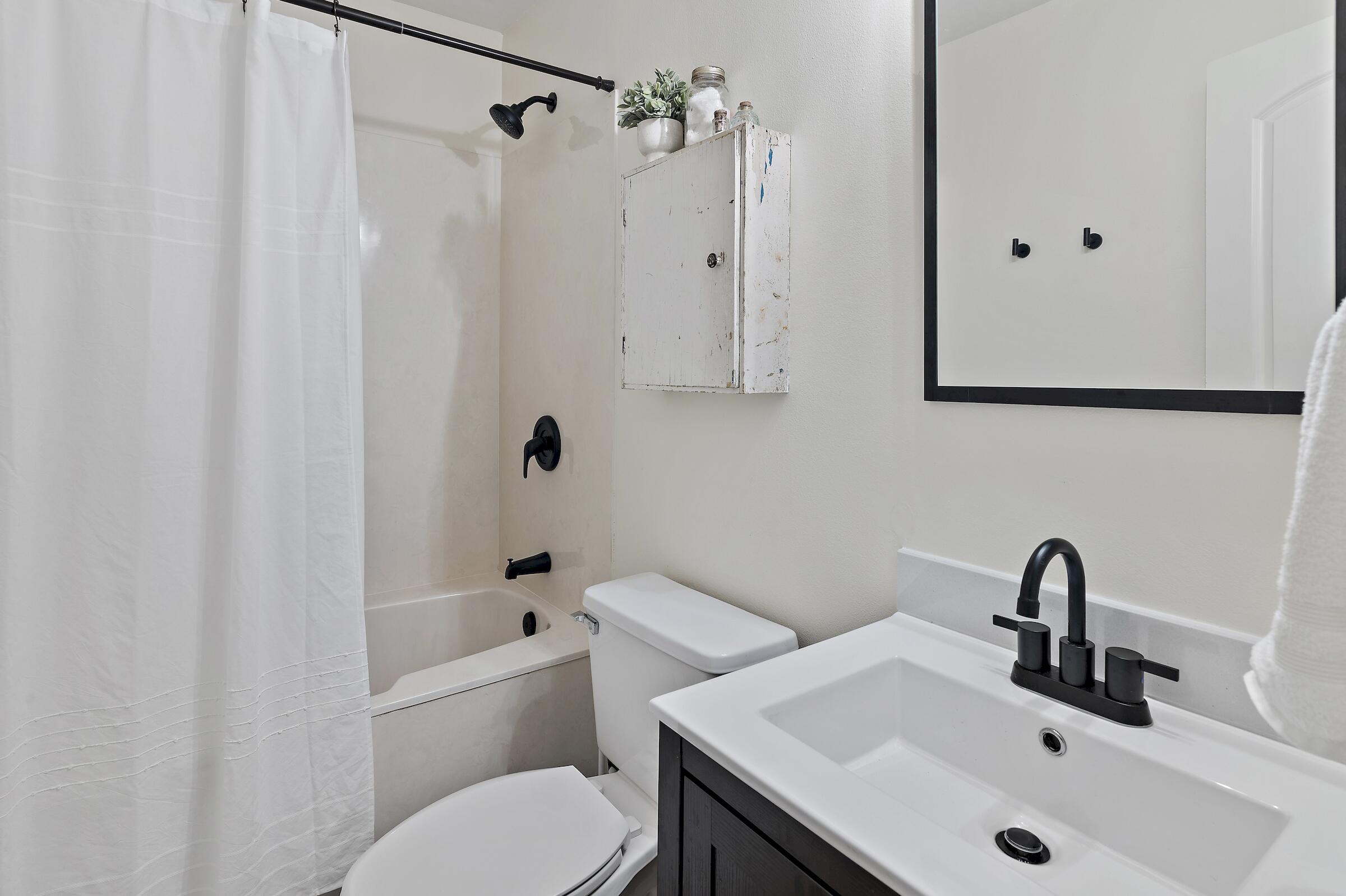 4485 Luke Avenue, Unit B Destin, FL 32541 - Photo 11 of 22 a bathroom with a sink a toilet and shower