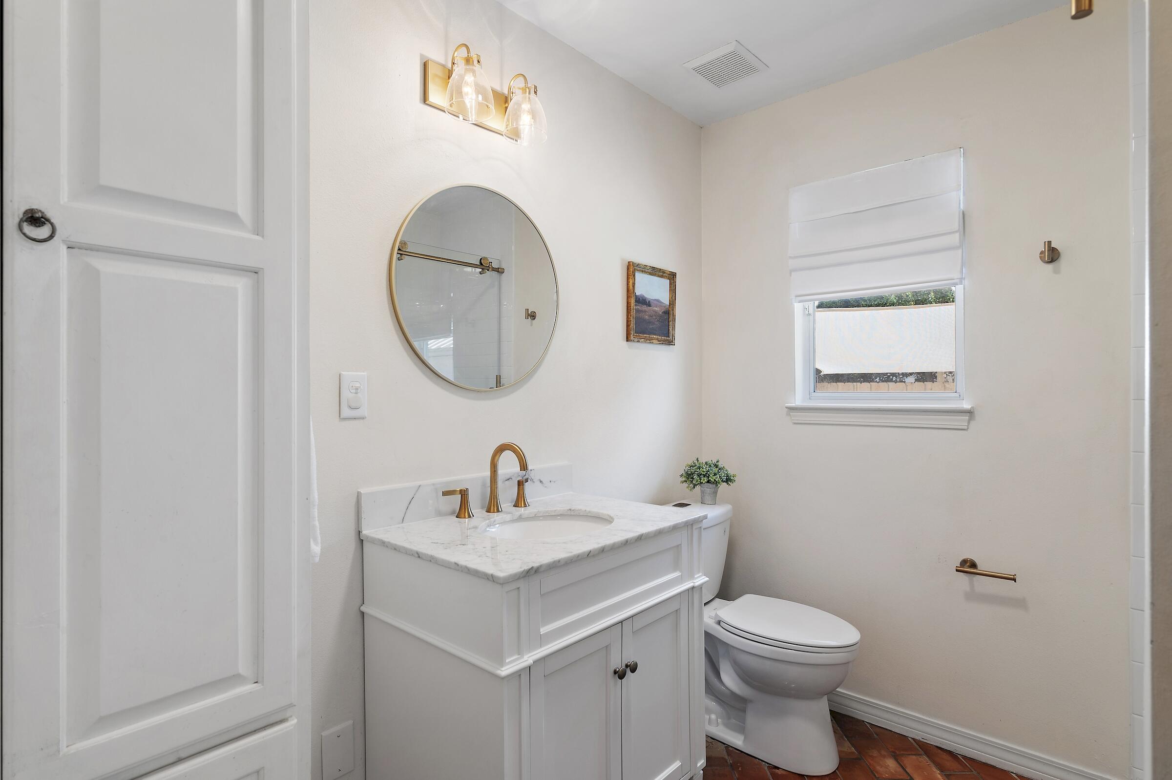 4485 Luke Avenue, Unit B Destin, FL 32541 - Photo 14 of 22 a bathroom with a toilet a sink and mirror