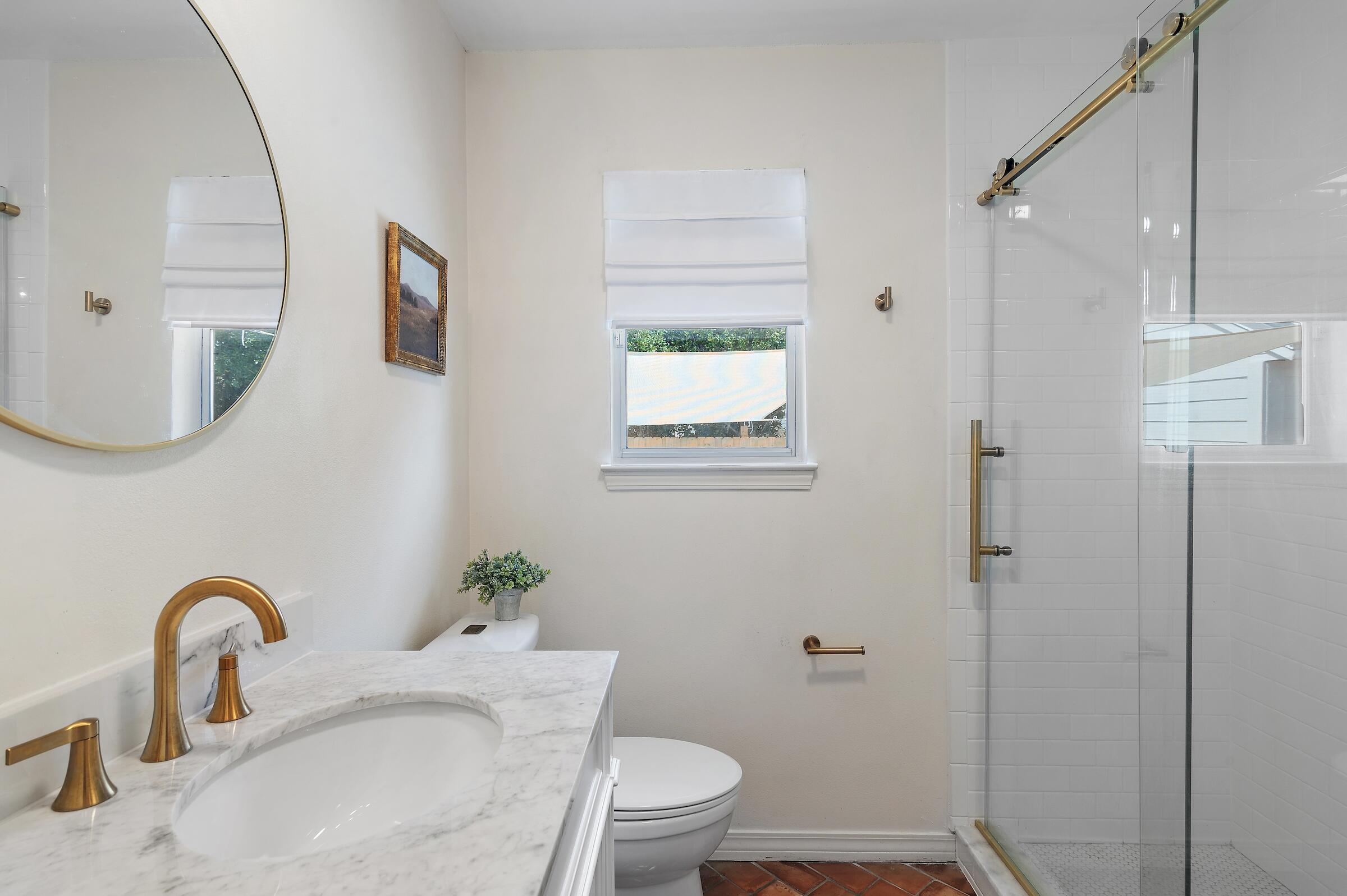 4485 Luke Avenue, Unit B Destin, FL 32541 - Photo 15 of 22 a bathroom with a granite countertop sink a toilet and a mirror