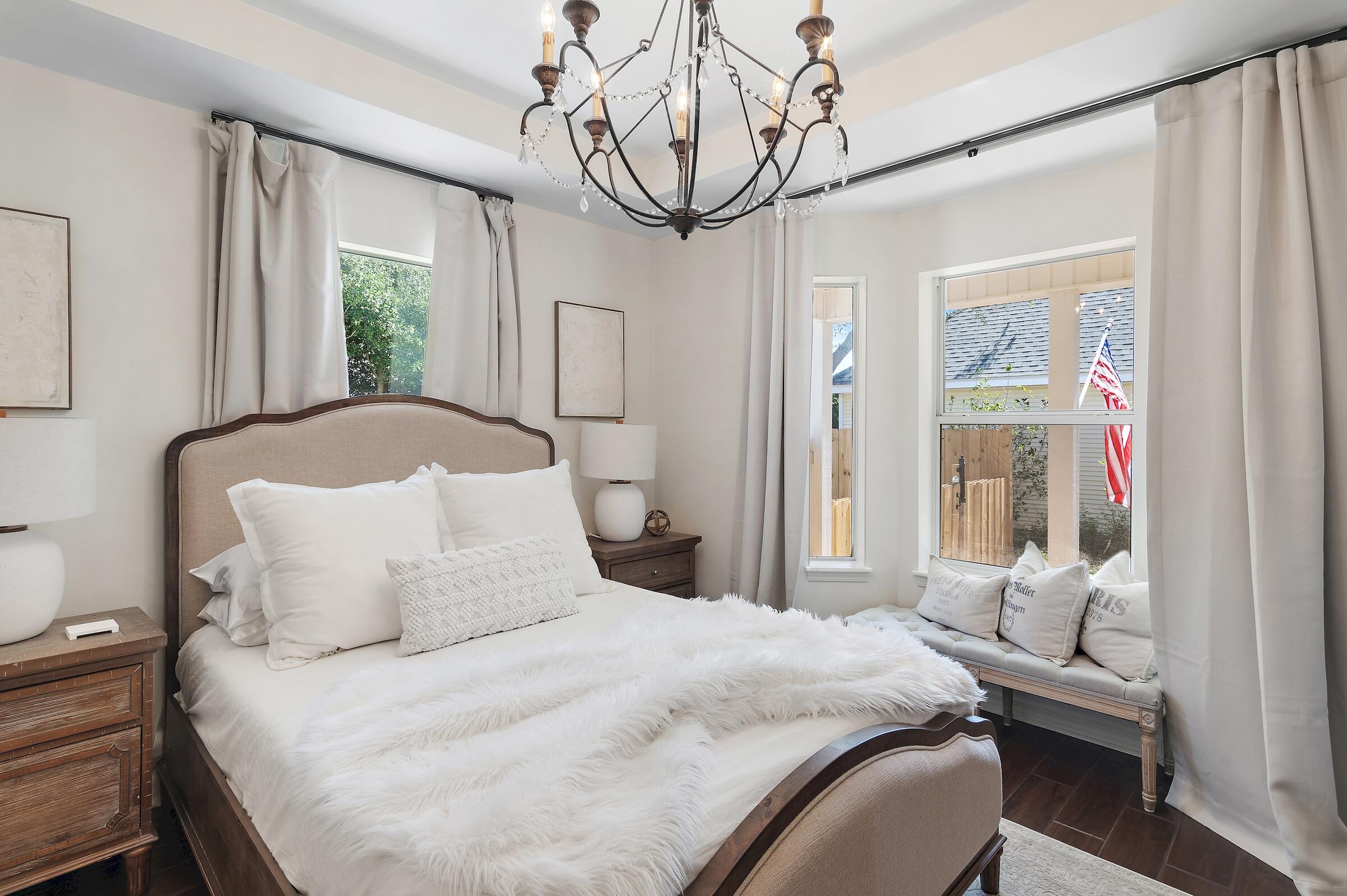 4485 Luke Avenue, Unit B Destin, FL 32541 - Photo 16 of 22 a bedroom with a bed and a chandelier