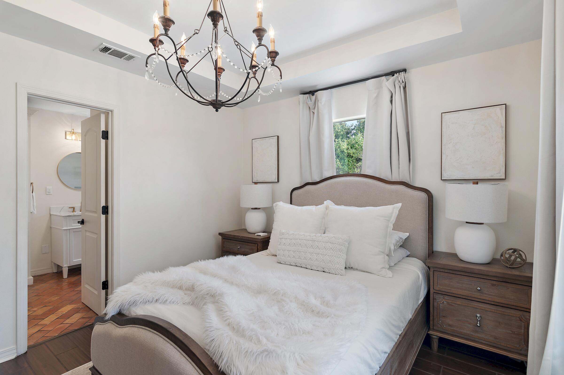 4485 Luke Avenue, Unit B Destin, FL 32541 - Photo 18 of 22 a bedroom with a bed and a chandelier