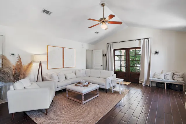 a living room with furniture and wooden floor