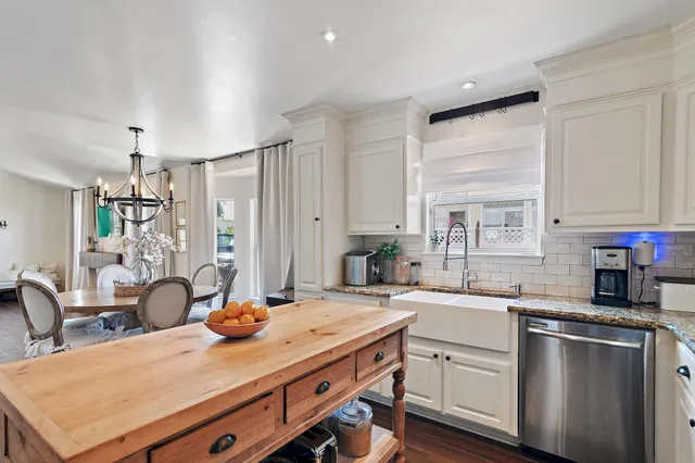 a kitchen with a sink appliances and cabinets