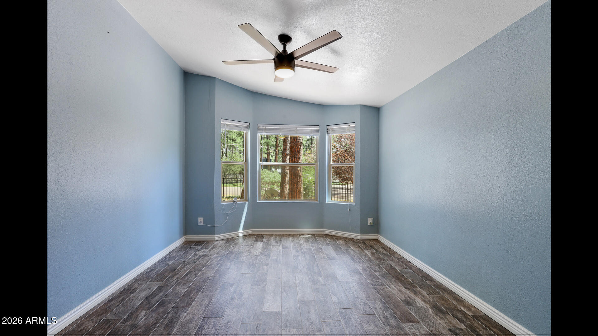 512 Standage Drive Payson, AZ 85541 - Photo 11 of 46 an empty room with wooden floor and windows