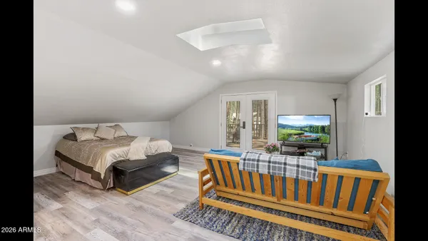 a living room with furniture a flat screen tv and a window