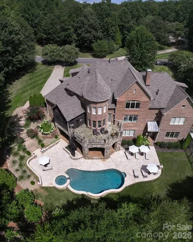 an aerial view of a house with garden space and lake view