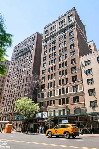 a living room with furniture and large windows