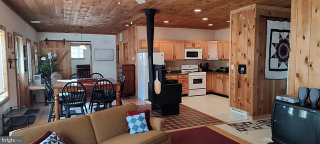 a view of a house with a backyard and wooden fence