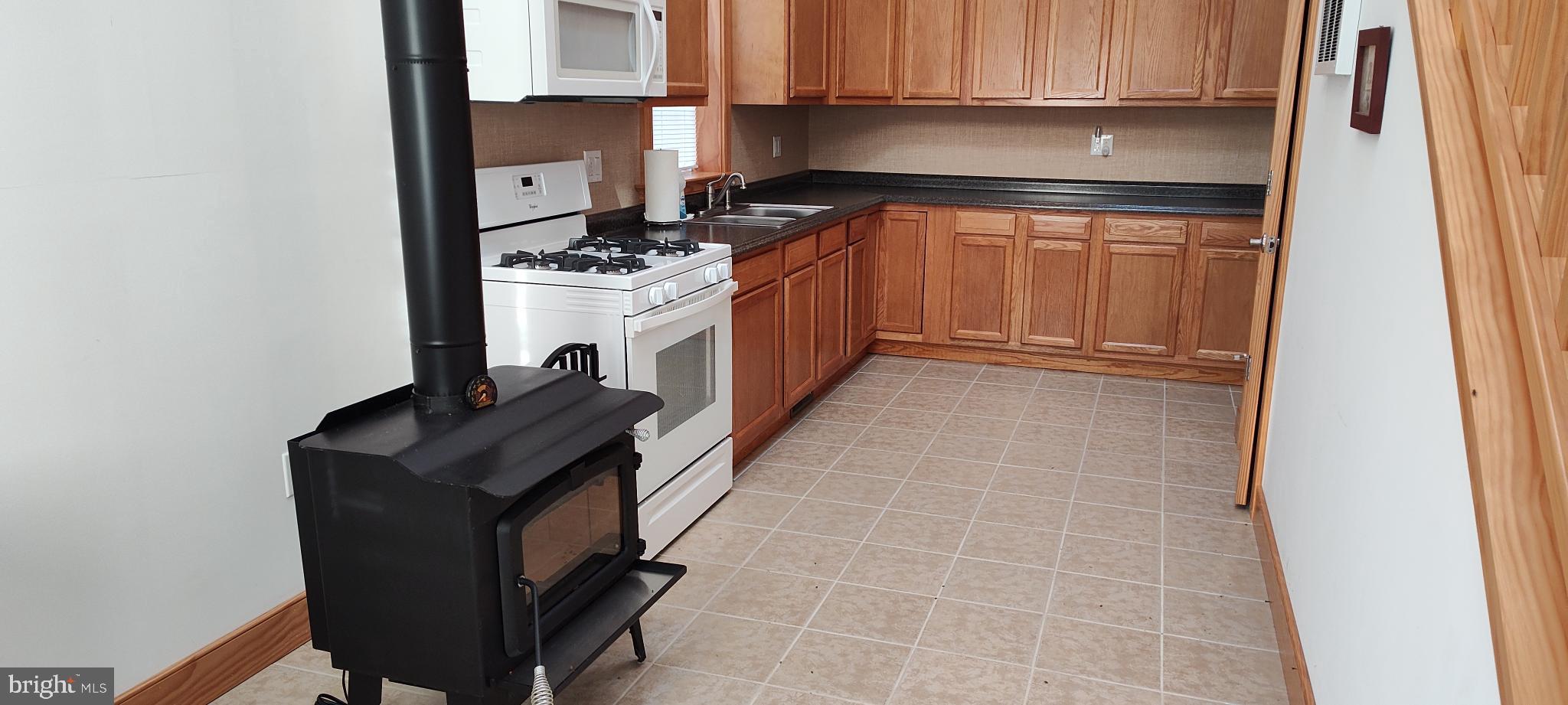 1339 Spruce Hill Road Port Royal, PA 17082 - Photo 31 of 126 a kitchen with stainless steel appliances granite countertop a sink stove and refrigerator