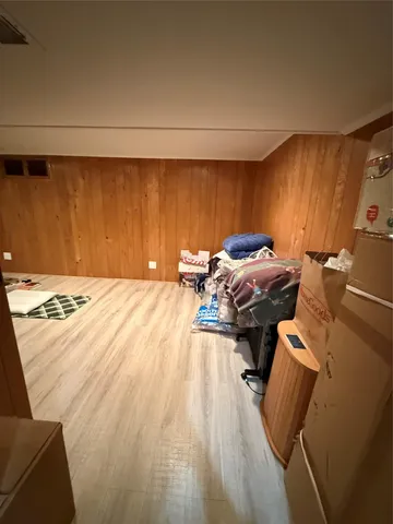 a bed sitting in a bedroom next to a lamp