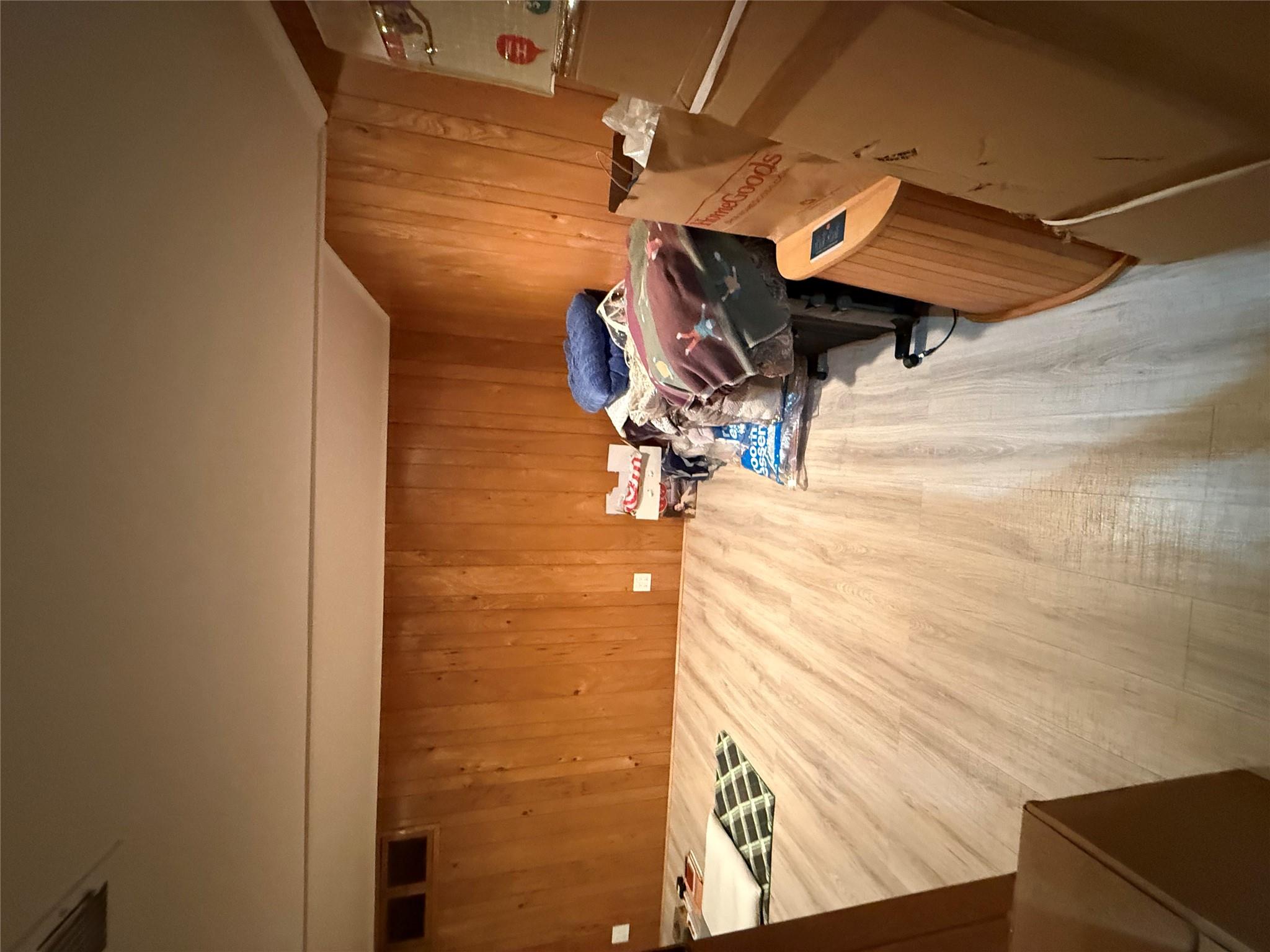 64-47 215th Street Queens, NY 11364 - Photo 15 of 15 a bed sitting in a bedroom next to a lamp