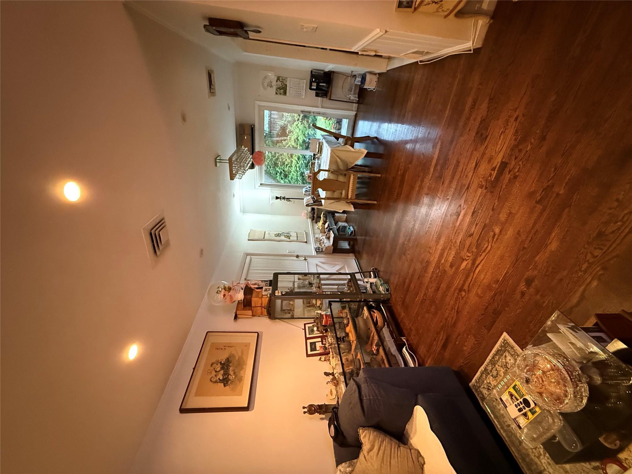 64-47 215th Street Queens, NY 11364 - Photo 2 of 15 a living room with furniture and a wooden floor