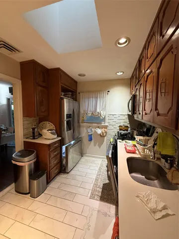 a kitchen with a sink appliances and cabinets