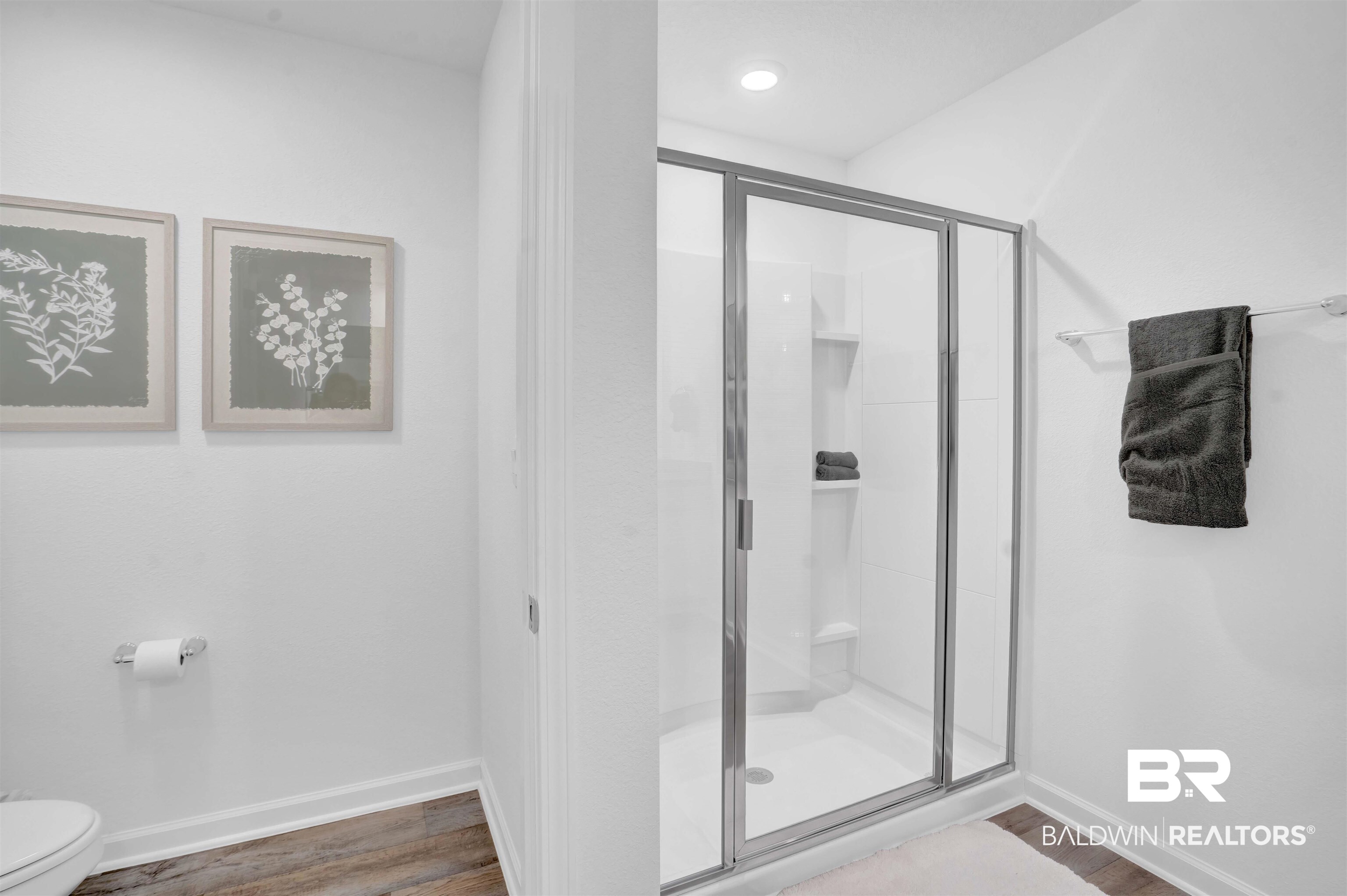 14717 Dayton Circle Foley, AL 36535 - Photo 26 of 39 Bathroom with hardwood / wood-style floors, toilet, and a shower with shower door