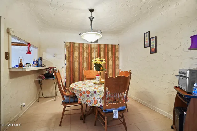 a dining room with furniture a chandelier and window