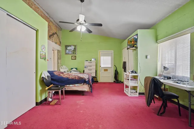 a bedroom with a bed a desk and chair