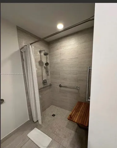a bathroom with a shower and a sink