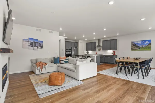 a living room with furniture kitchen view and a dining table